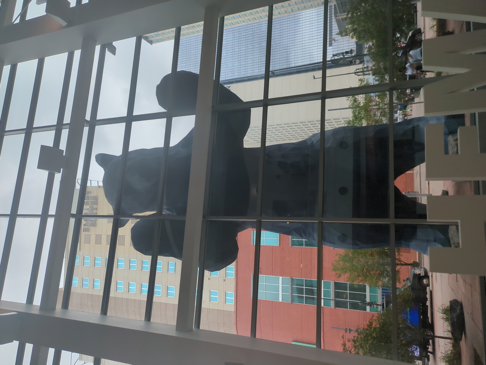 A big, blue, bear peering in on the Colorado Convention Center.